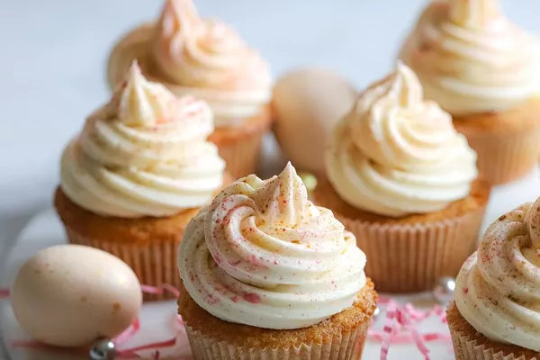 Coconut Cupcakes with Pineapple Curd and Speckled Malt Buttercream Frosting