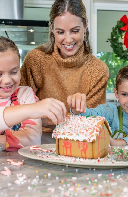 family making a gingerbread house together with C&H® baking tips
