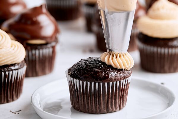 piping salted caramel c&h frosting on hi-hat cupcakes